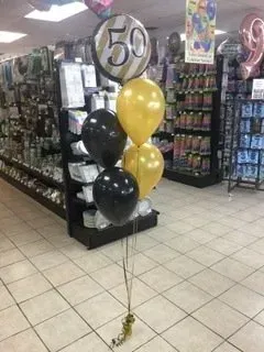 A bunch of balloons are sitting in a store.