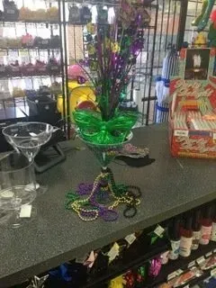 A mardi gras decoration is sitting on a counter in a store.