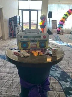 A table with a boombox on it in a room.