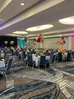 A room with a table and balloons in it.