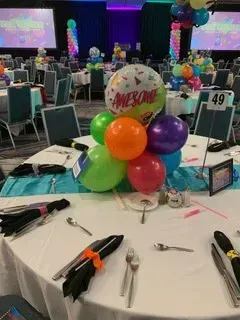 A table with a bunch of balloons on it