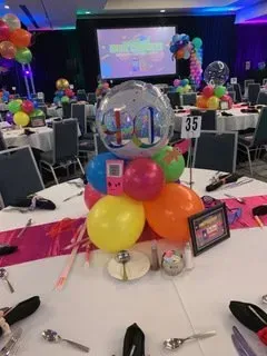 A table with balloons and a sign that says 35 on it