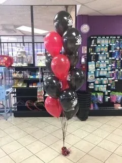A bunch of red and black balloons in a store