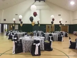 A room decorated with balloons and lights for a party.