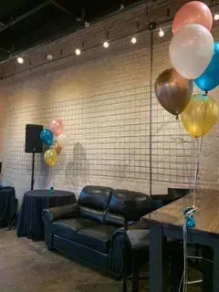 A living room with a couch , table , and balloons.