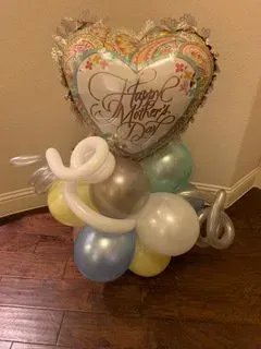 A bunch of balloons are sitting on a wooden floor.