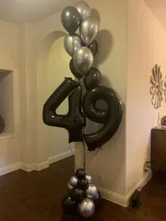 A bunch of balloons are sitting on top of each other in a room.