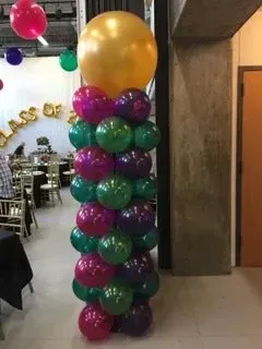 A stack of balloons sitting on top of each other in a room.