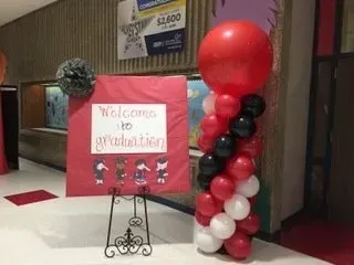 There is a sign that says welcome to graduation on it.