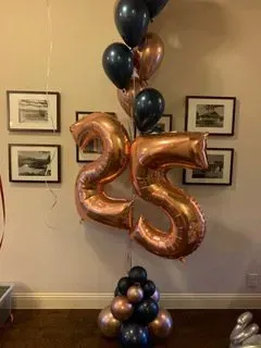 A bunch of balloons are sitting on top of each other in a room.