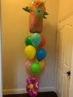 A bunch of balloons are stacked on top of each other in a hallway.