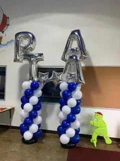 A room filled with blue and white balloons and letters.
