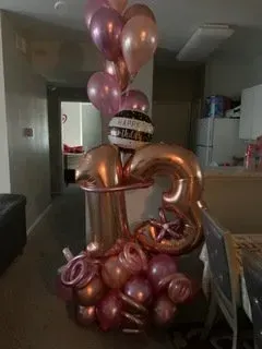 A bunch of balloons are sitting on top of each other in a room.