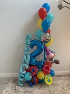 A bunch of balloons are sitting on the floor in a room.