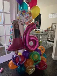 A bunch of balloons are sitting on the floor in a room.
