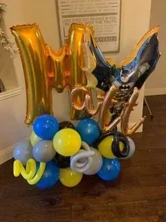 A bunch of balloons are sitting on a wooden floor.