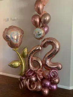 A bunch of balloons are sitting on the floor in a room.