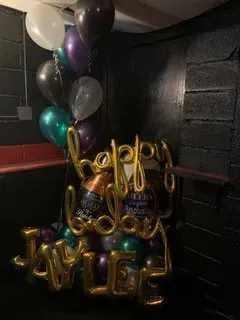 A bunch of balloons are sitting on top of each other in a room.