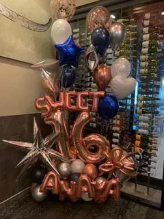 A room decorated with balloons and lights for a party.