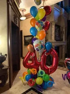 A bunch of balloons are stacked on top of each other in a room.