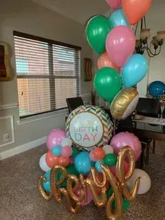 A bunch of balloons are sitting on the floor in a room.