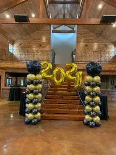 A bunch of balloons are stacked on top of each other in a hallway.