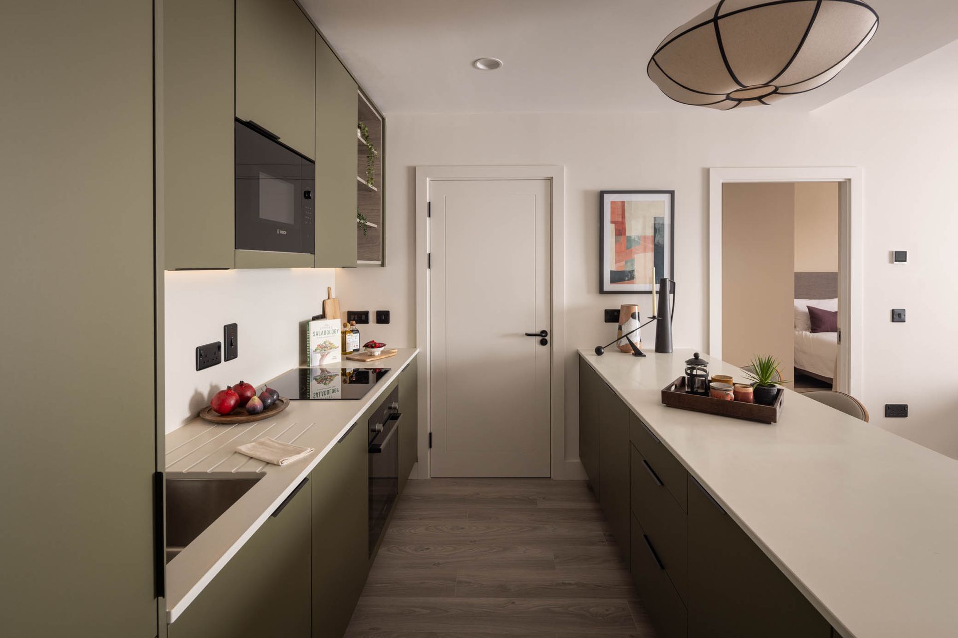 Modern kitchen with a long island, built-in cabinets, and neutral-toned decor.