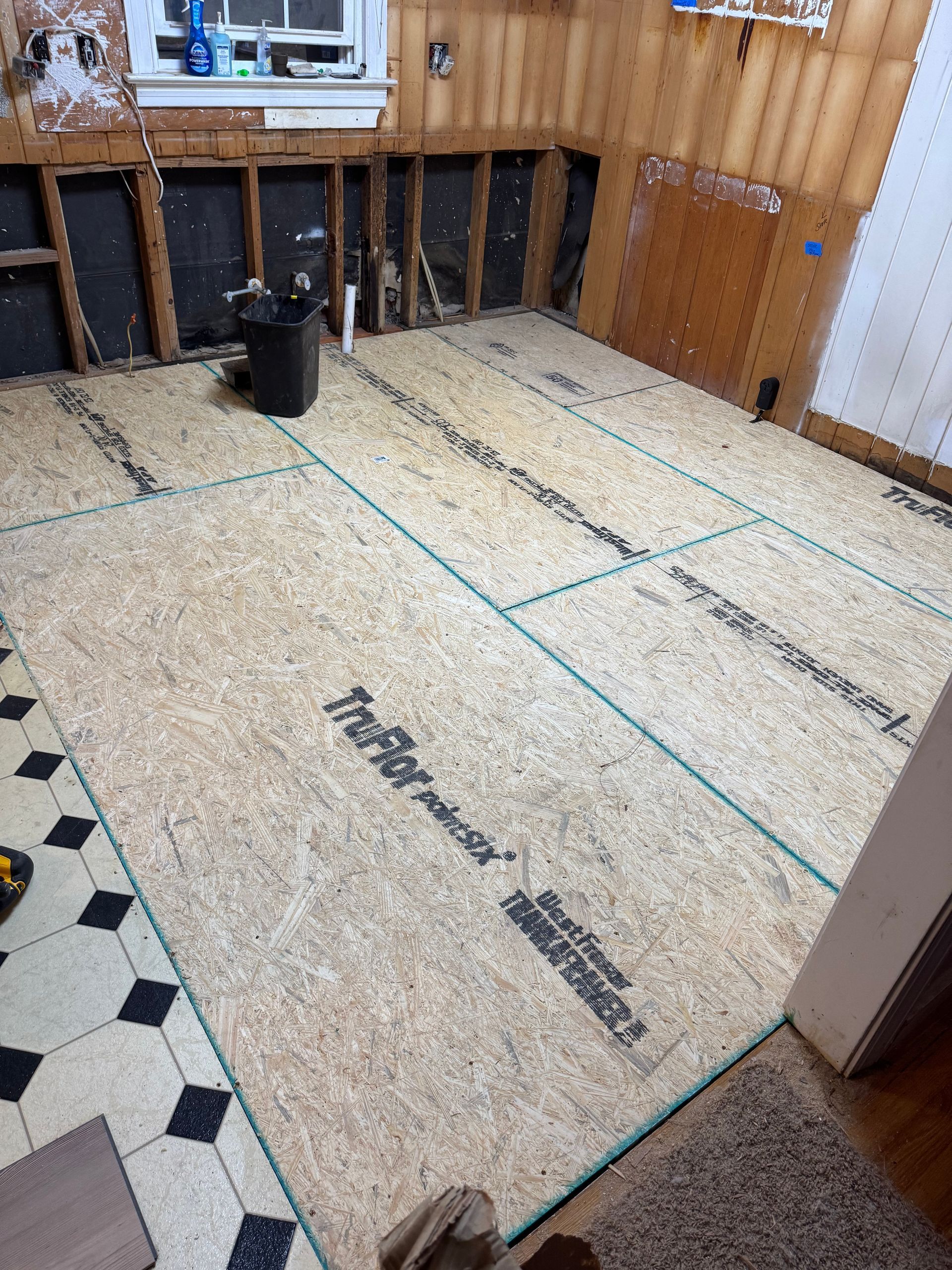 Construction site floor with insulation boards and taped seams in a room under renovation