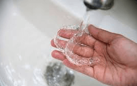 Cleaning clear retainer — Buffalo Grove, IL — Rosen Orthodontics Cleaning clear retainer — Buffalo Grove, IL — Rosen Orthodontics