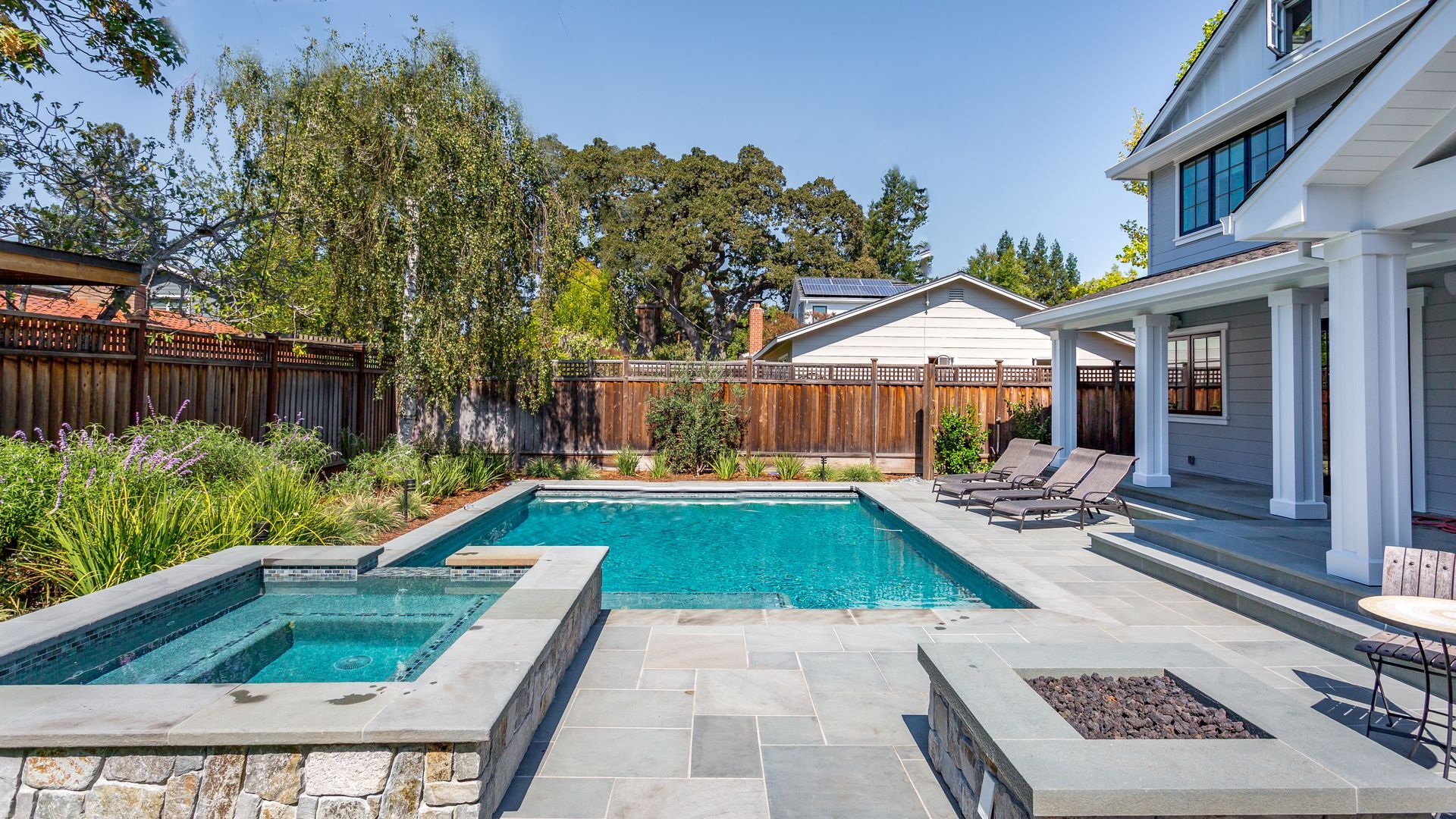 Elite Outdoor Living Solutions is installing a backyard swimming pool for a modern home in Oklahoma City.