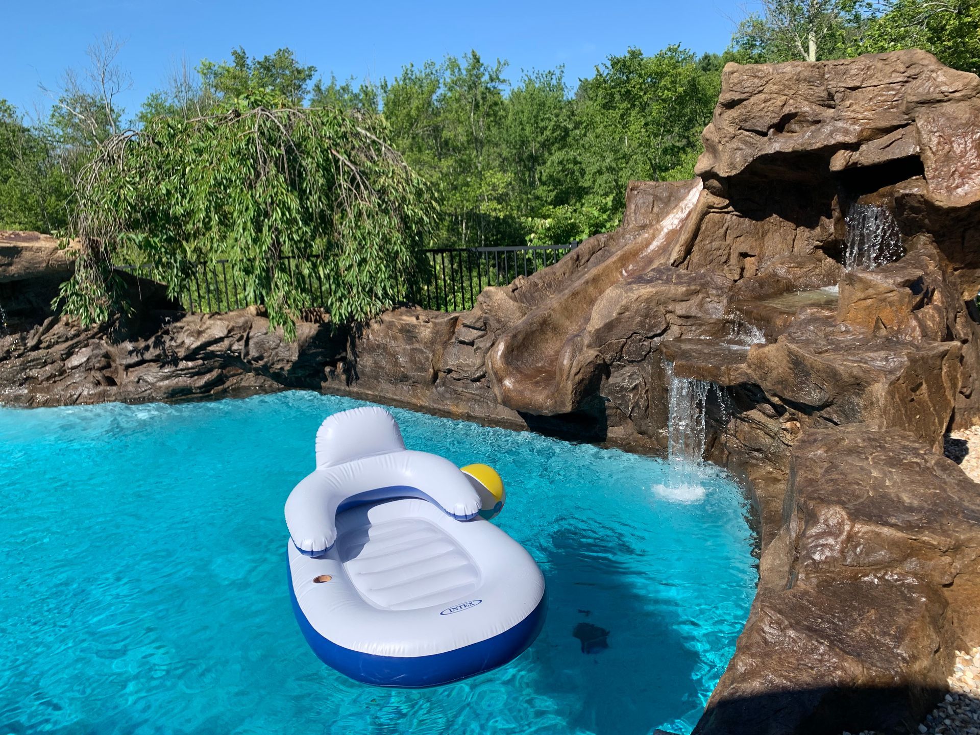 Elite Outdoor Living Solutions is installing a custom swimming pool with a waterfall in Oklahoma City.
