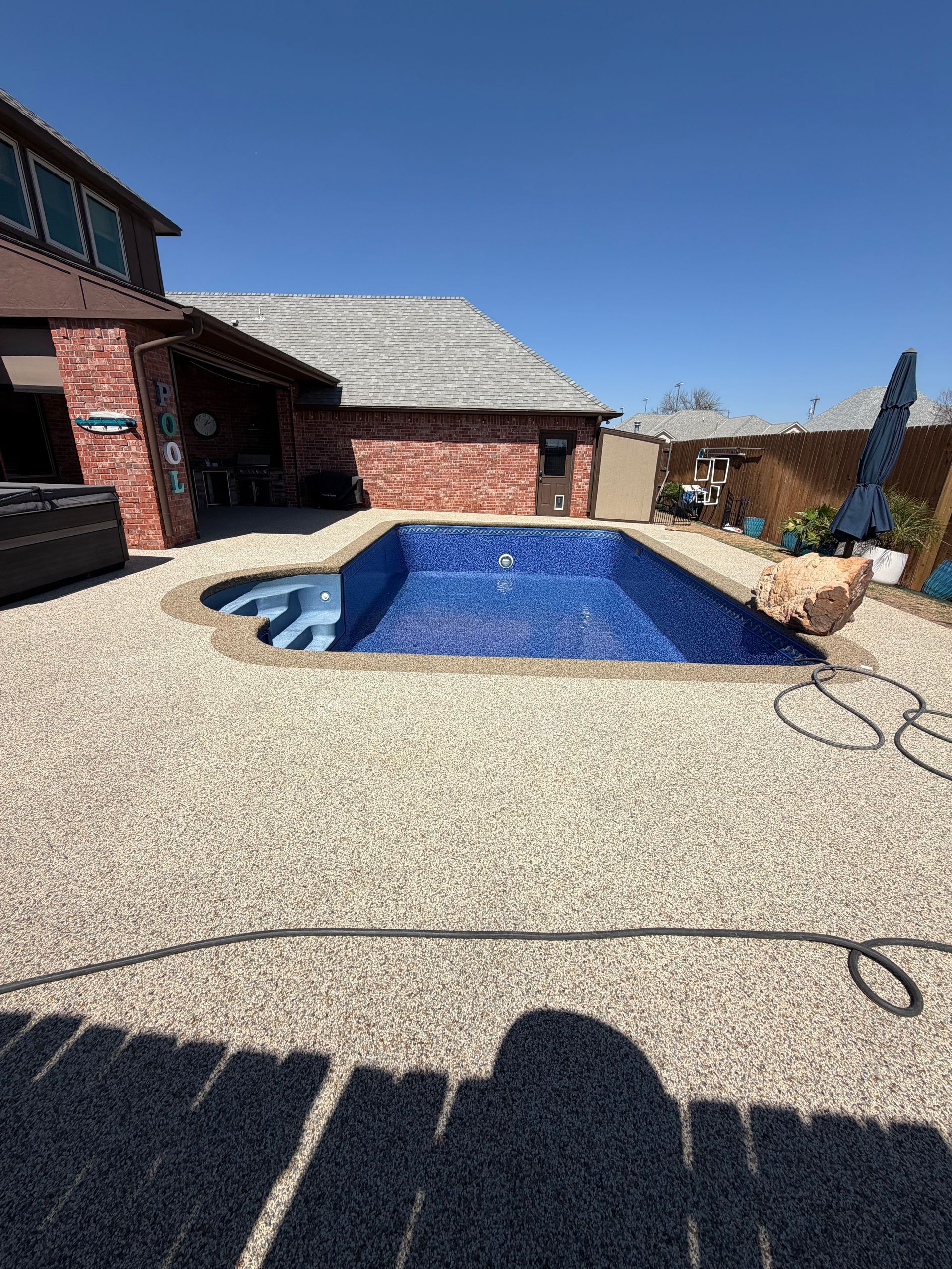 Elite Outdoor Living Solutions is designing a custom pool for a residential backyard in Oklahoma City.