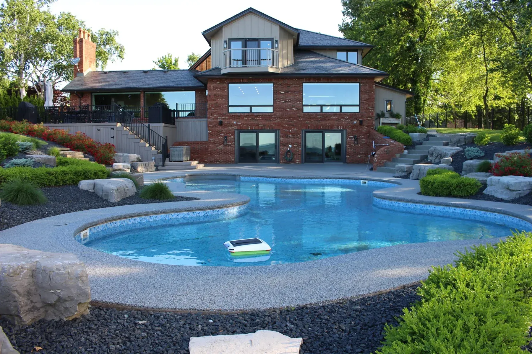 Elite Outdoor Living Solutions is installing a custom swimming pool with a waterfall in Oklahoma City.