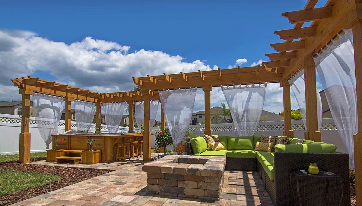 Elite Outdoor Living Solutions created a custom patio featuring a pergola, fire pit, and outdoor furniture in Yukon, OK.