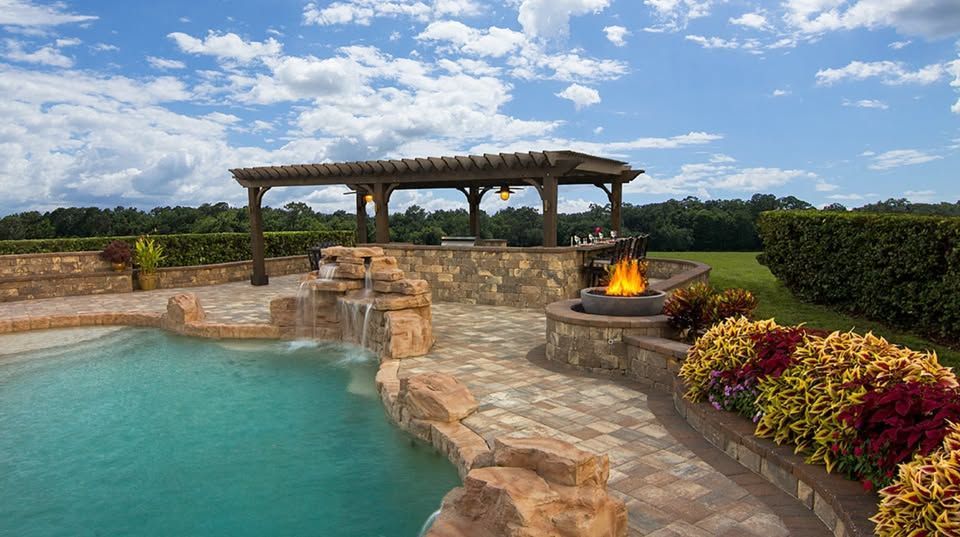 Elite Outdoor Living Solutions built a patio featuring a pergola, firepit and swimming pool in  Heritage Hills, OKC.