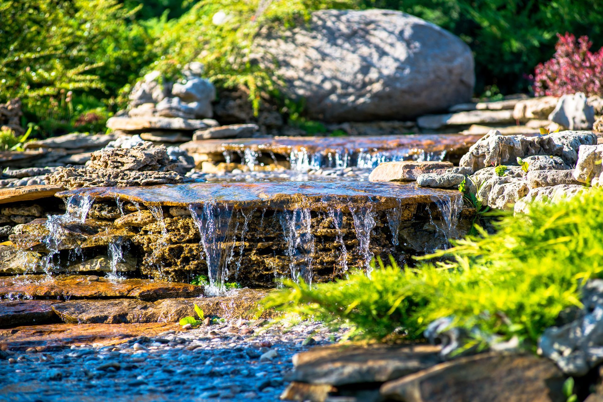 Elite Outdoor Living Solutions is installing a custom swimming pool with a waterfall in Oklahoma City.