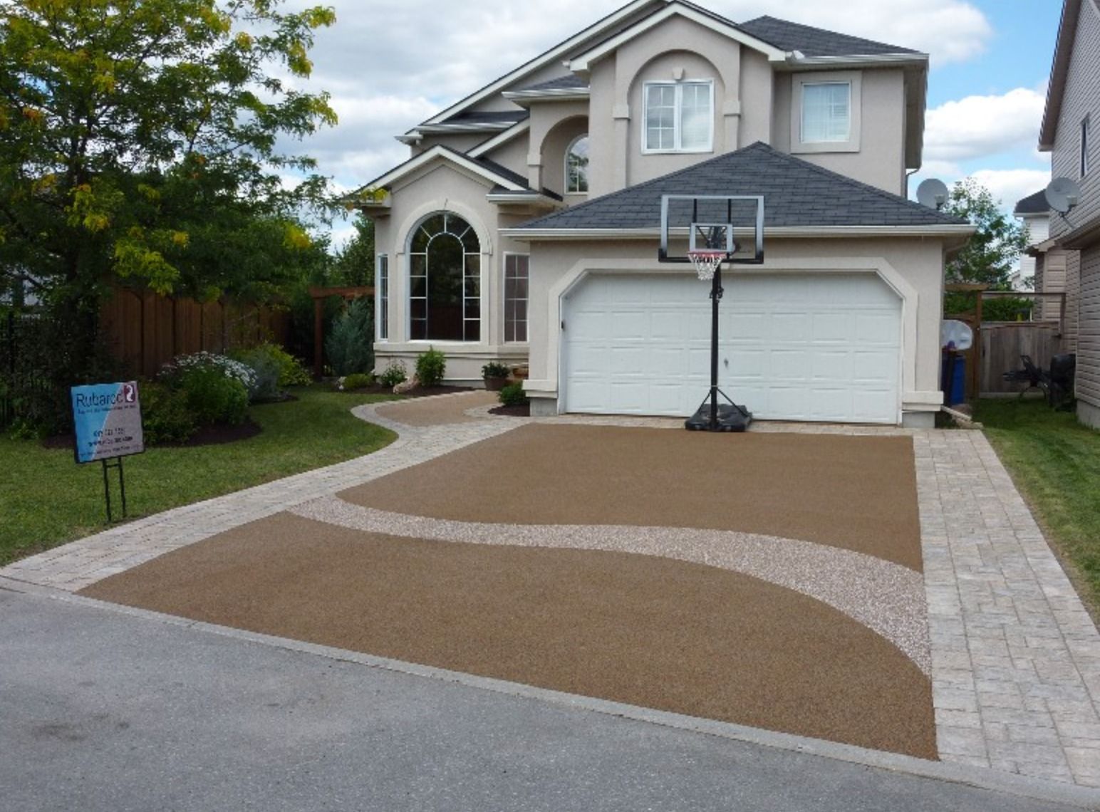 A large house with a basketball hoop in front of it