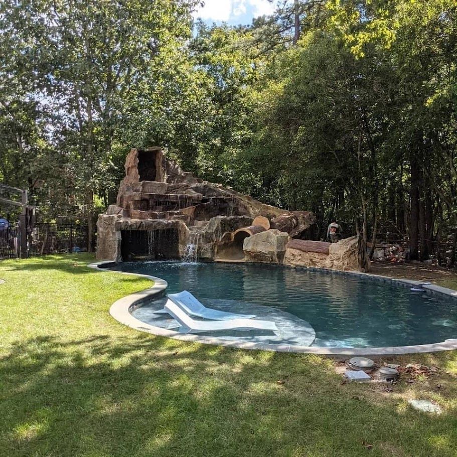 Elite Outdoor Living Solutions is installing a backyard swimming pool with a rock waterfall in Yukon, OK.