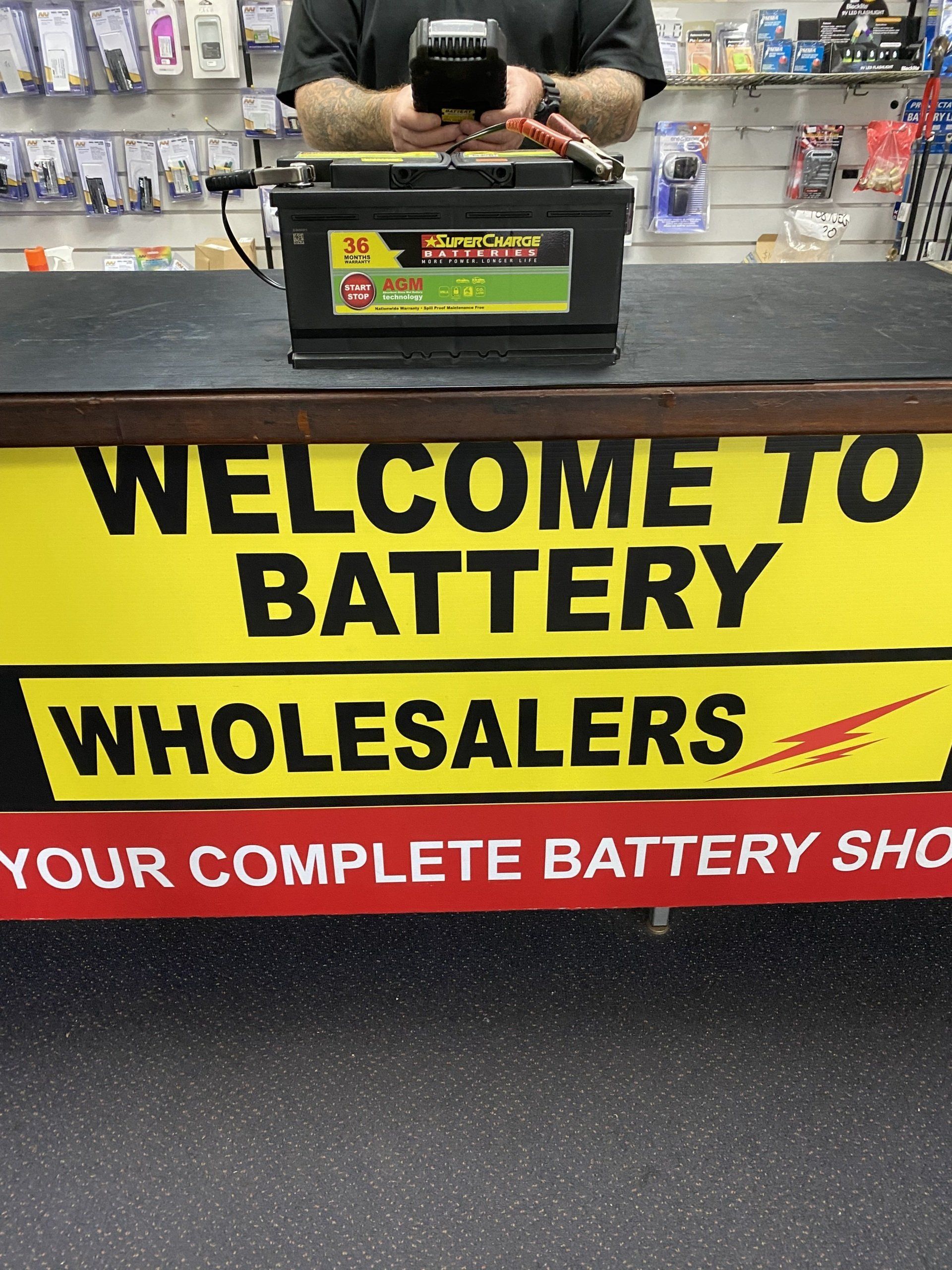 electrician installing battery in car