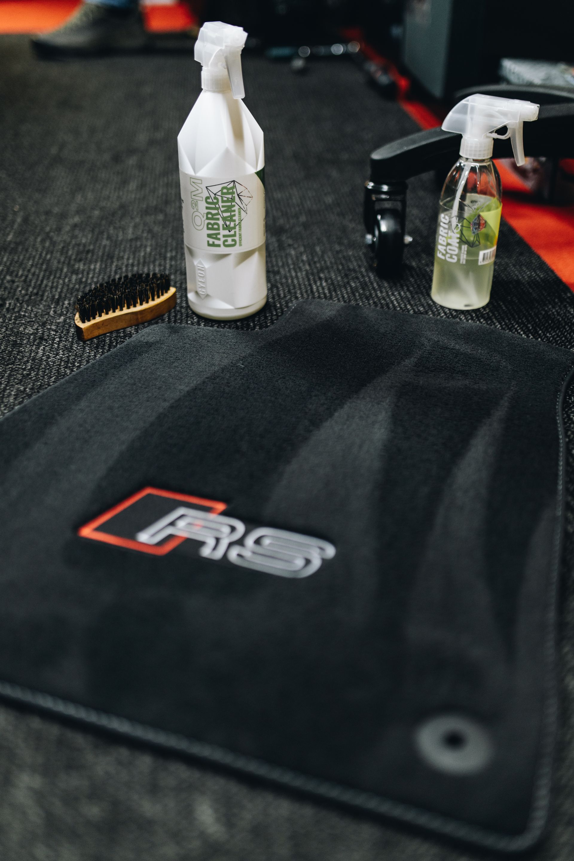 Black Grs Detailing Mat with Spray Bottles and Brush on Top — Straightline Detailing Cairns in Bungalow, QLD