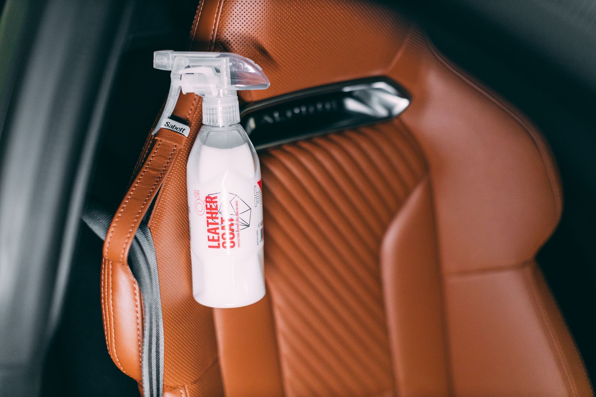 White Leather Cleaner Spray Bottle Hanging — Straightline Detailing Cairns in Bungalow, QLD