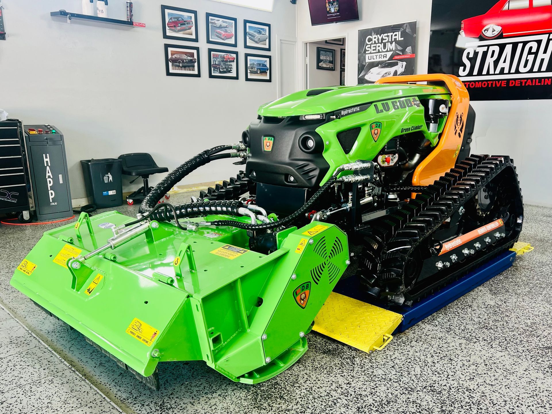 Bright Green and Orange Lawn Mower in A Workshop — Straightline Detailing Cairns in Bungalow, QLD