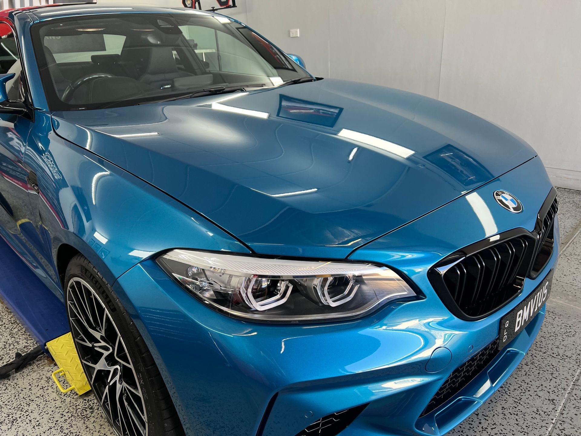 Blue BMW Coupe in A Garage — Straightline Detailing Cairns in Bungalow, QLD