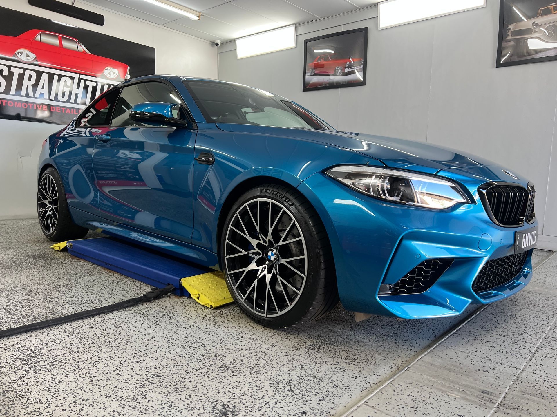 Blue BMW Sports Car on A Lift in A Garage — Straightline Detailing Cairns in Bungalow, QLD
