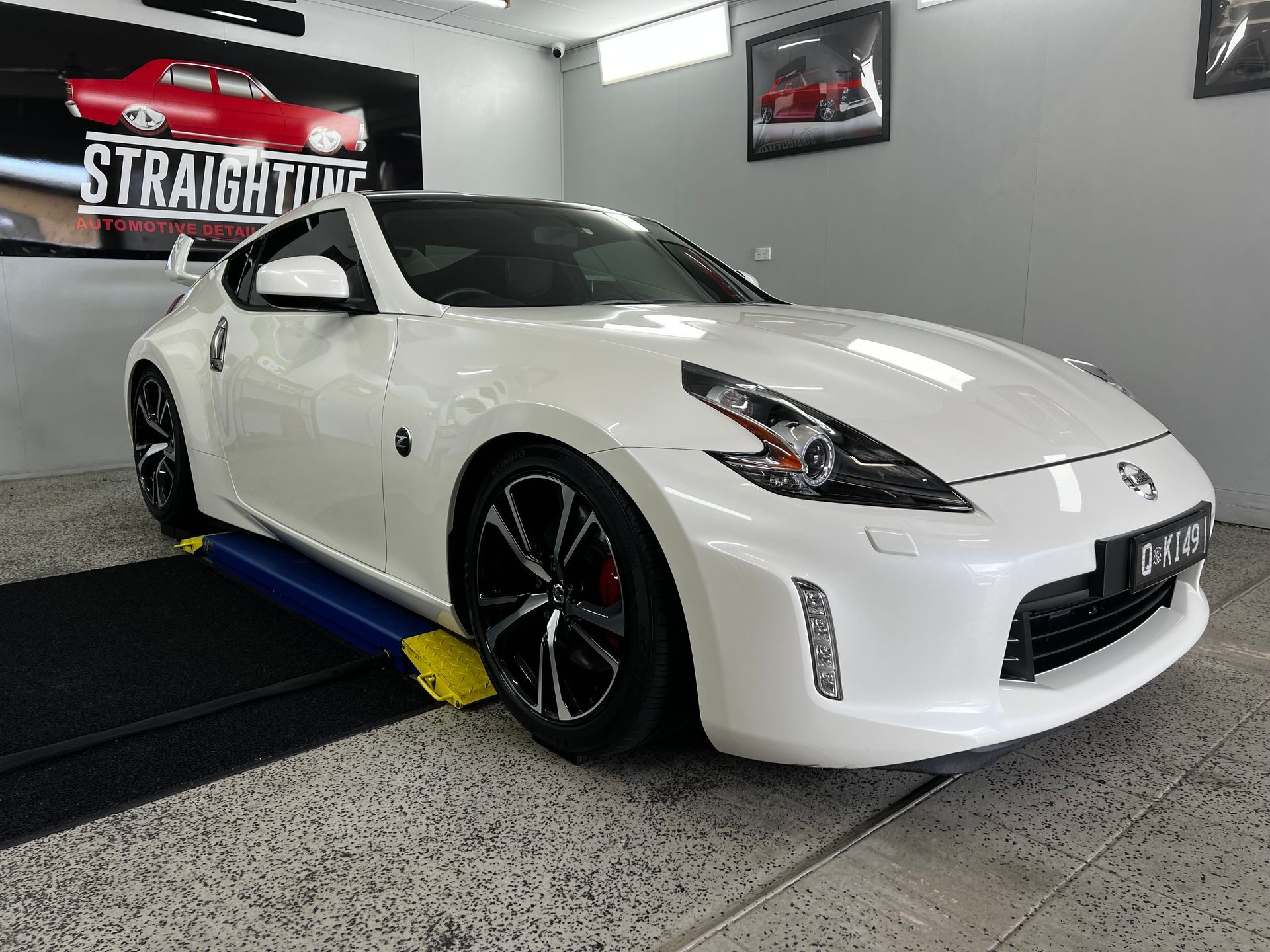 White Nissan 370 Z in A Showroom — Straightline Detailing Cairns in Bungalow, QLD