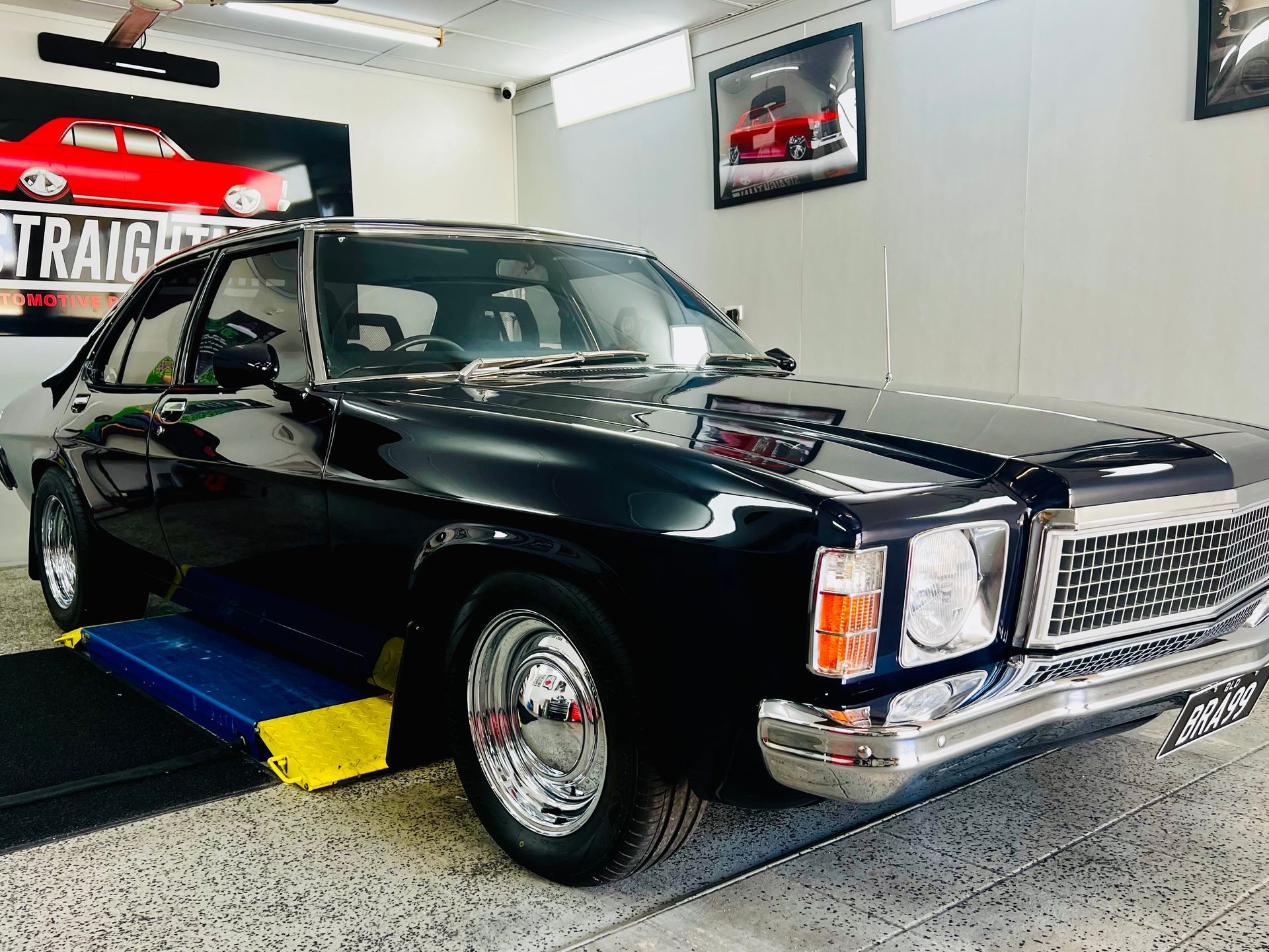 Black Vintage Pickup Truck on A Platform in A Garage Showroom — Straightline Detailing Cairns in Bungalow, QLD