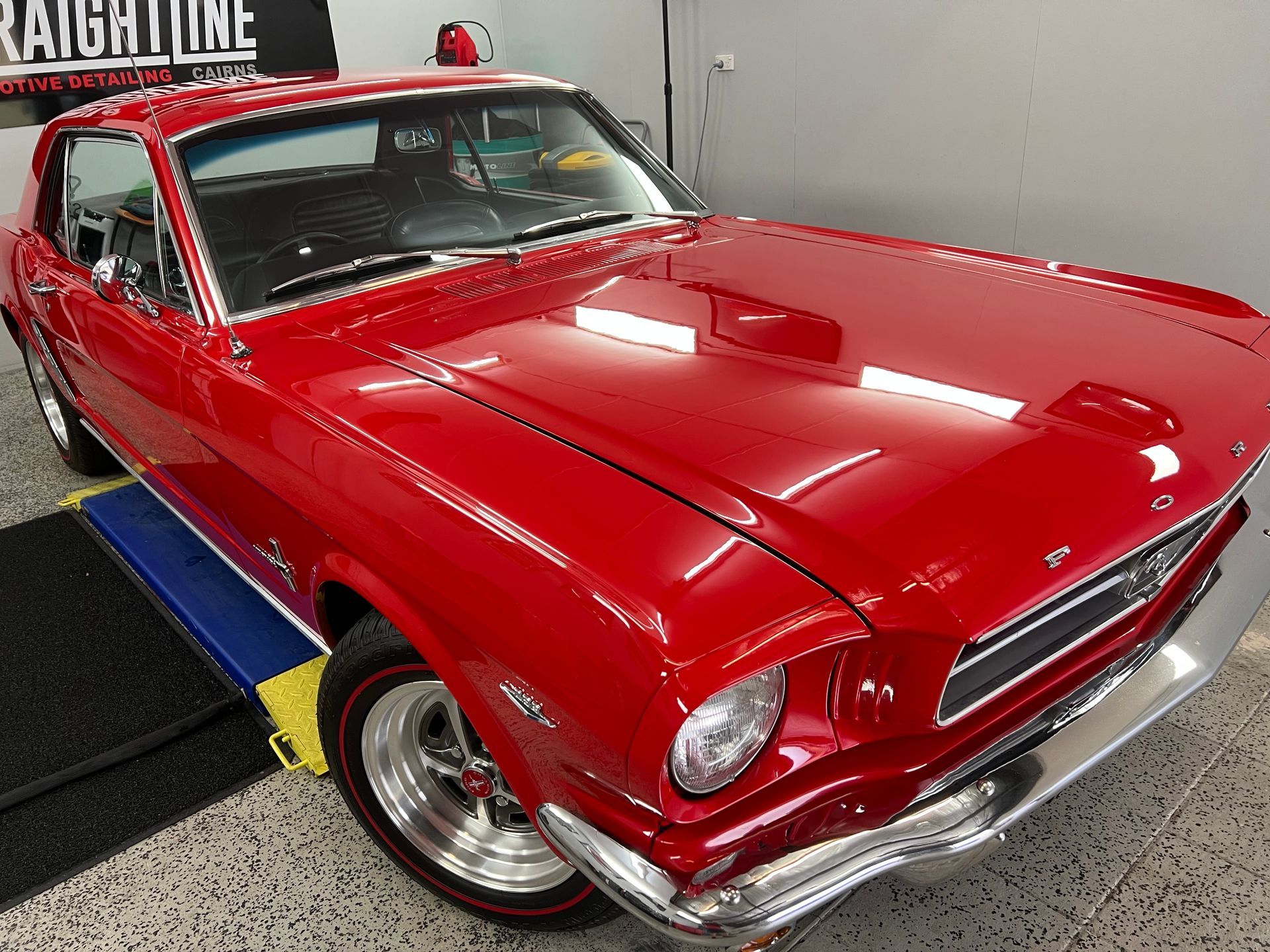 Shiny Red Classic Car in An Indoor Showroom — Straightline Detailing Cairns in Bungalow, QLD