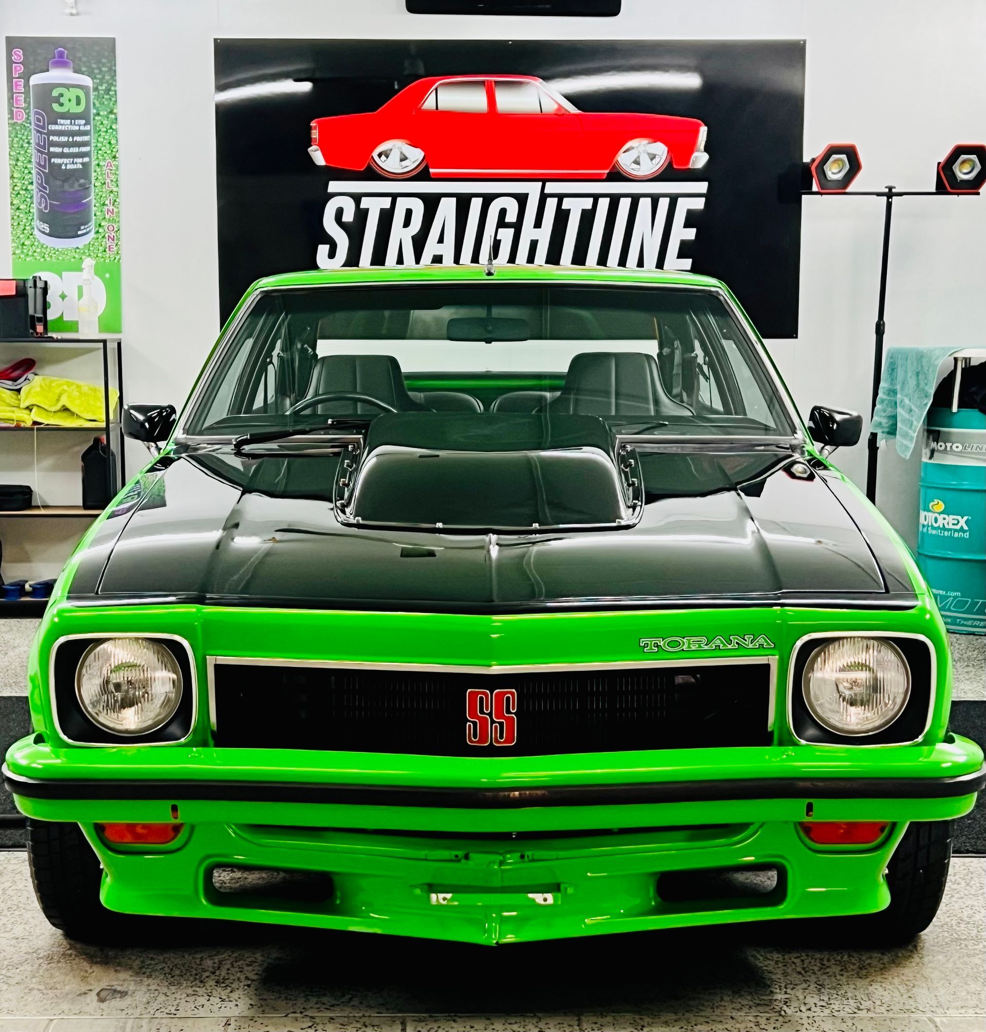 Front View of A Black-And-Green Classic Muscle Car in A Garage — Straightline Detailing Cairns in Bungalow, QLD