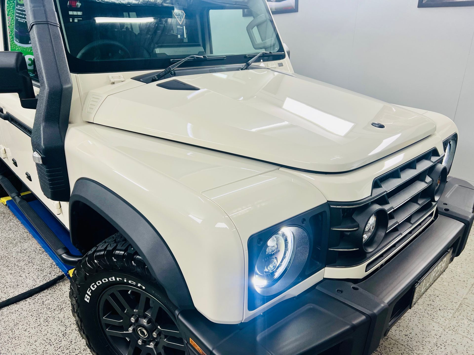 White off-road SUV With Headlights On — Straightline Detailing Cairns in Bungalow, QLD