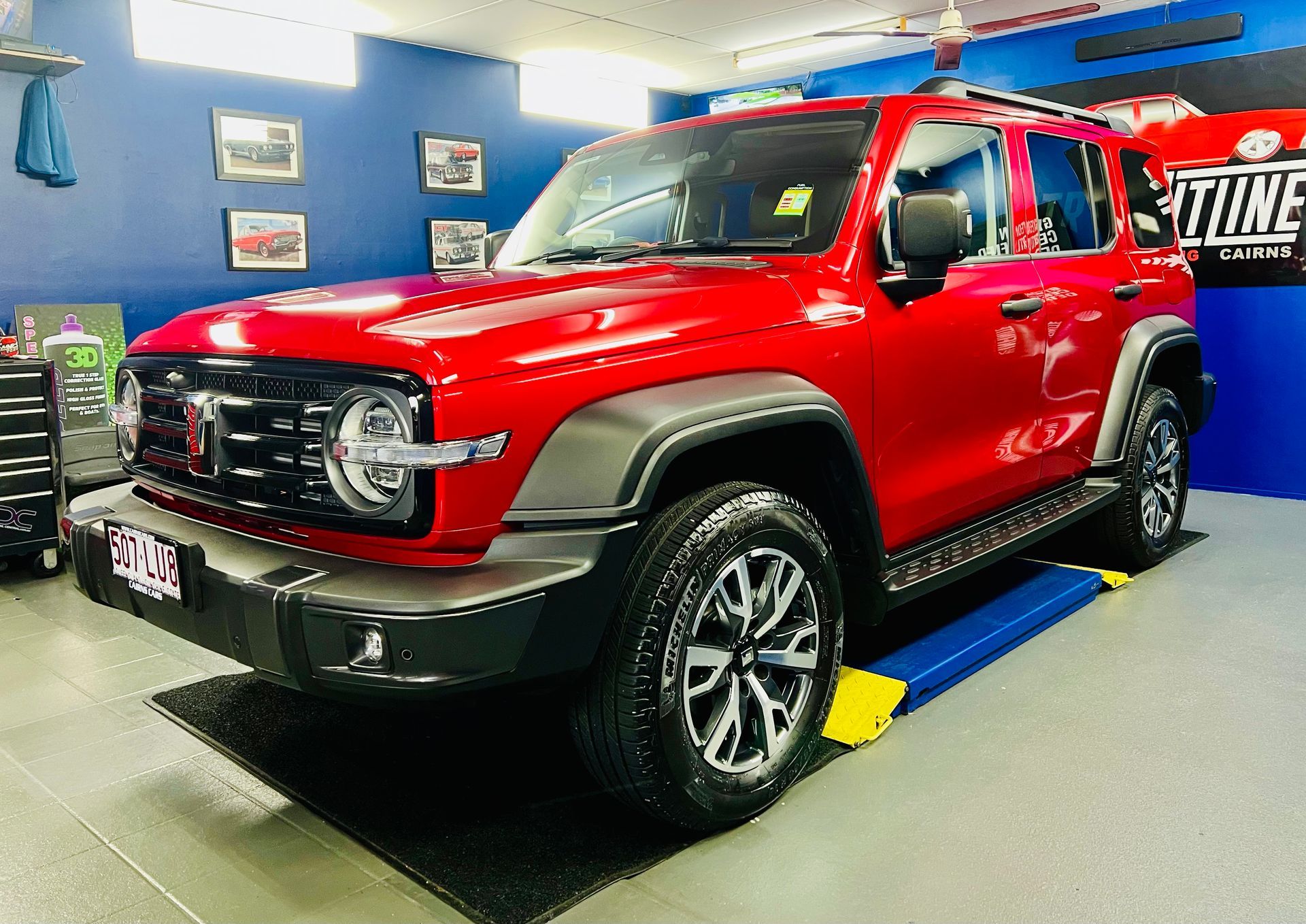Red Off-Road Suv on A Showroom Floor — Straightline Detailing Cairns in Bungalow, QLD